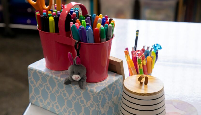 a stack of pens and pencils on a table